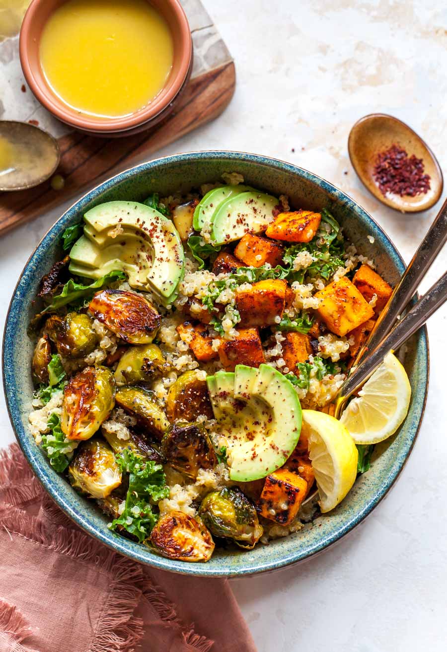 Quinoa and veggies in a bowl with dressing