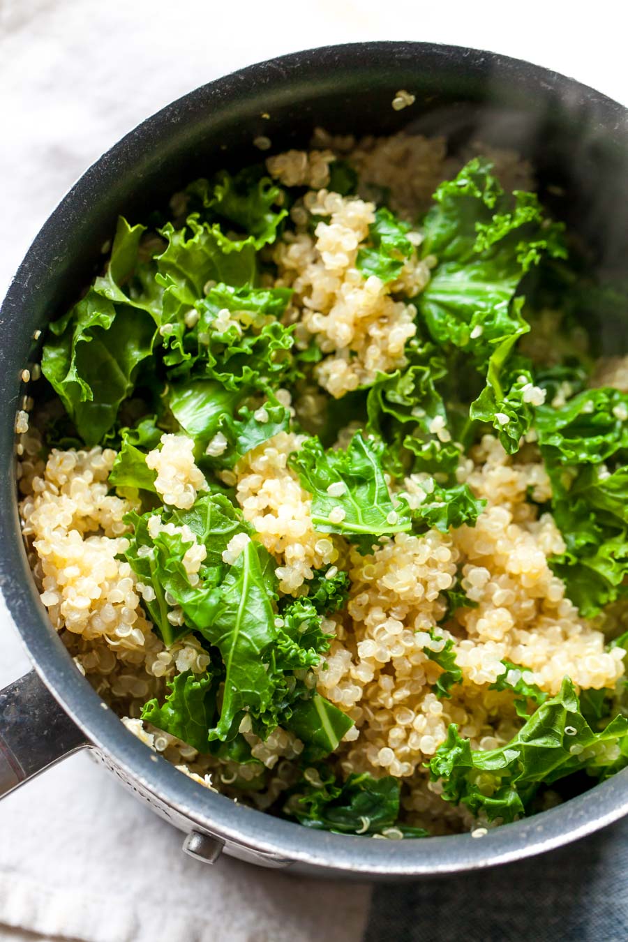 Cooked quinoa in a pan with kale