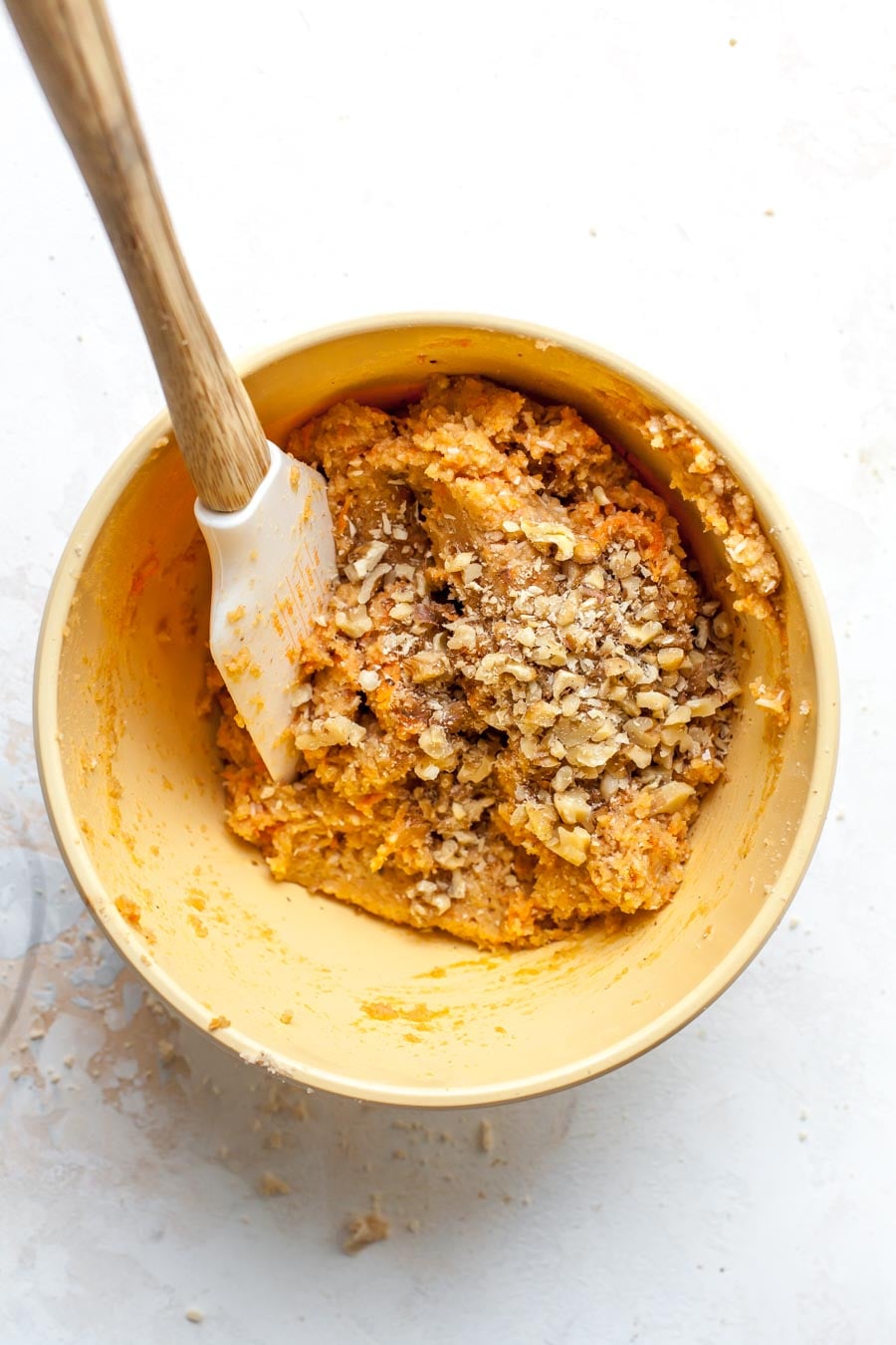 Walnuts and coconut being mixed into scone dough.