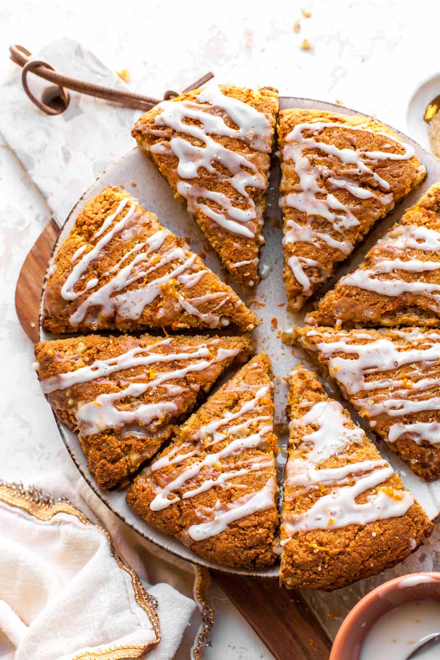 Almond flour scones being sliced into wedges on a cutting board.