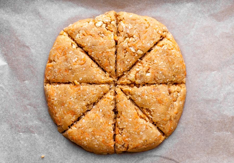 Scone dough being formed into a disc and sliced into wedges.