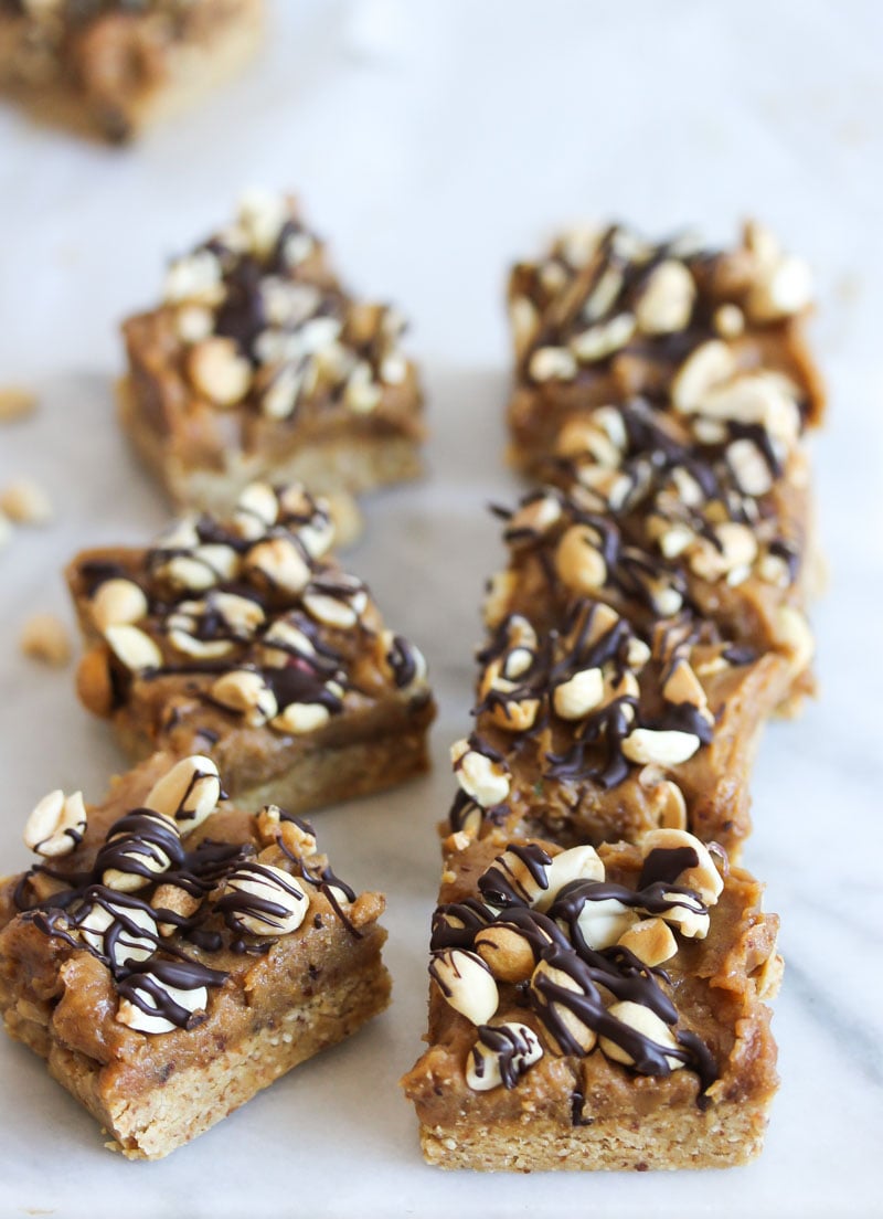 Peanut butter snickers bars sliced into 10 pieces on a cutting board