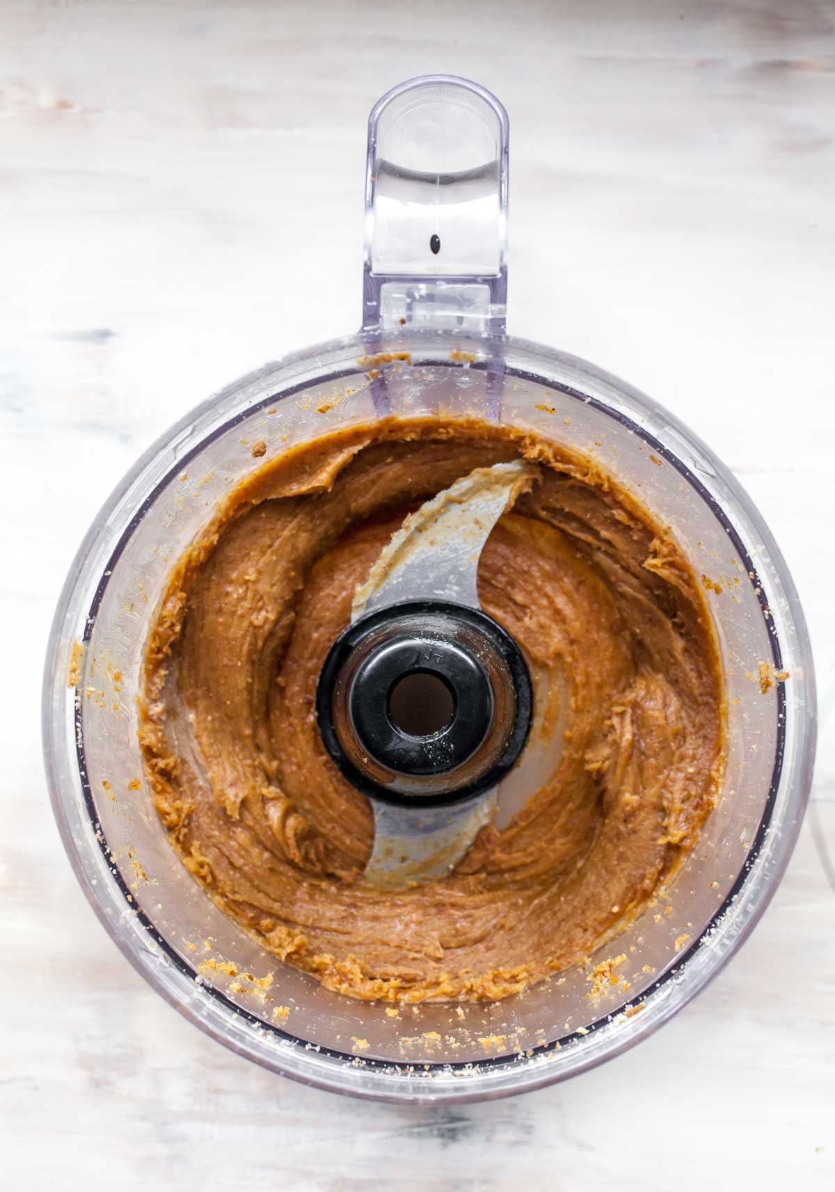 Dates and peanut butter blended into a creamy consistency in a food processor