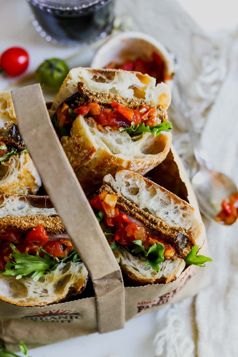 Eggplant sandwiches arranged in a brown picnic bag