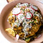 Pesto-Roasted Whole Cauliflower with Creamy Garlic Sauce
