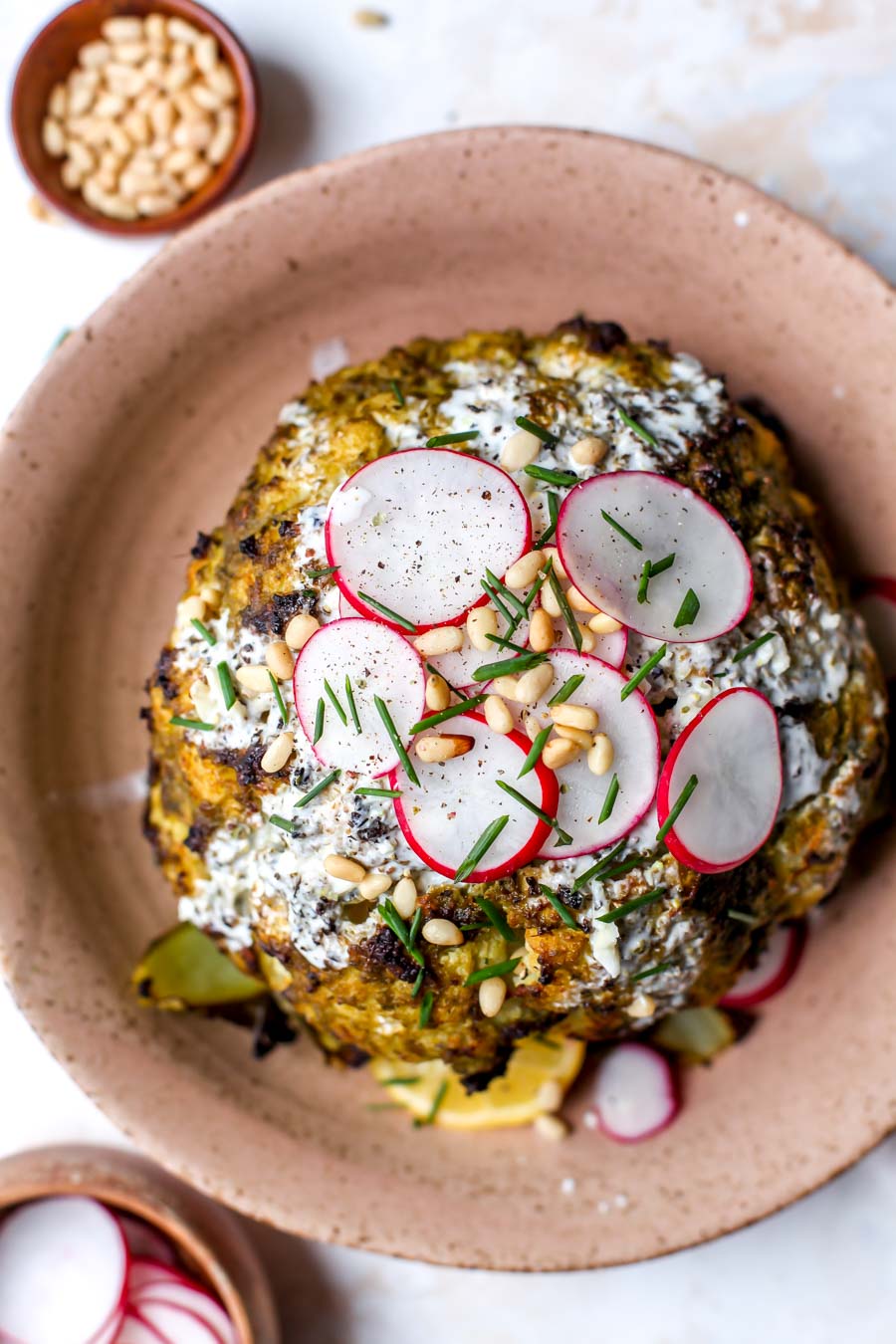 Pesto-Roasted Whole Cauliflower with Creamy Garlic Sauce