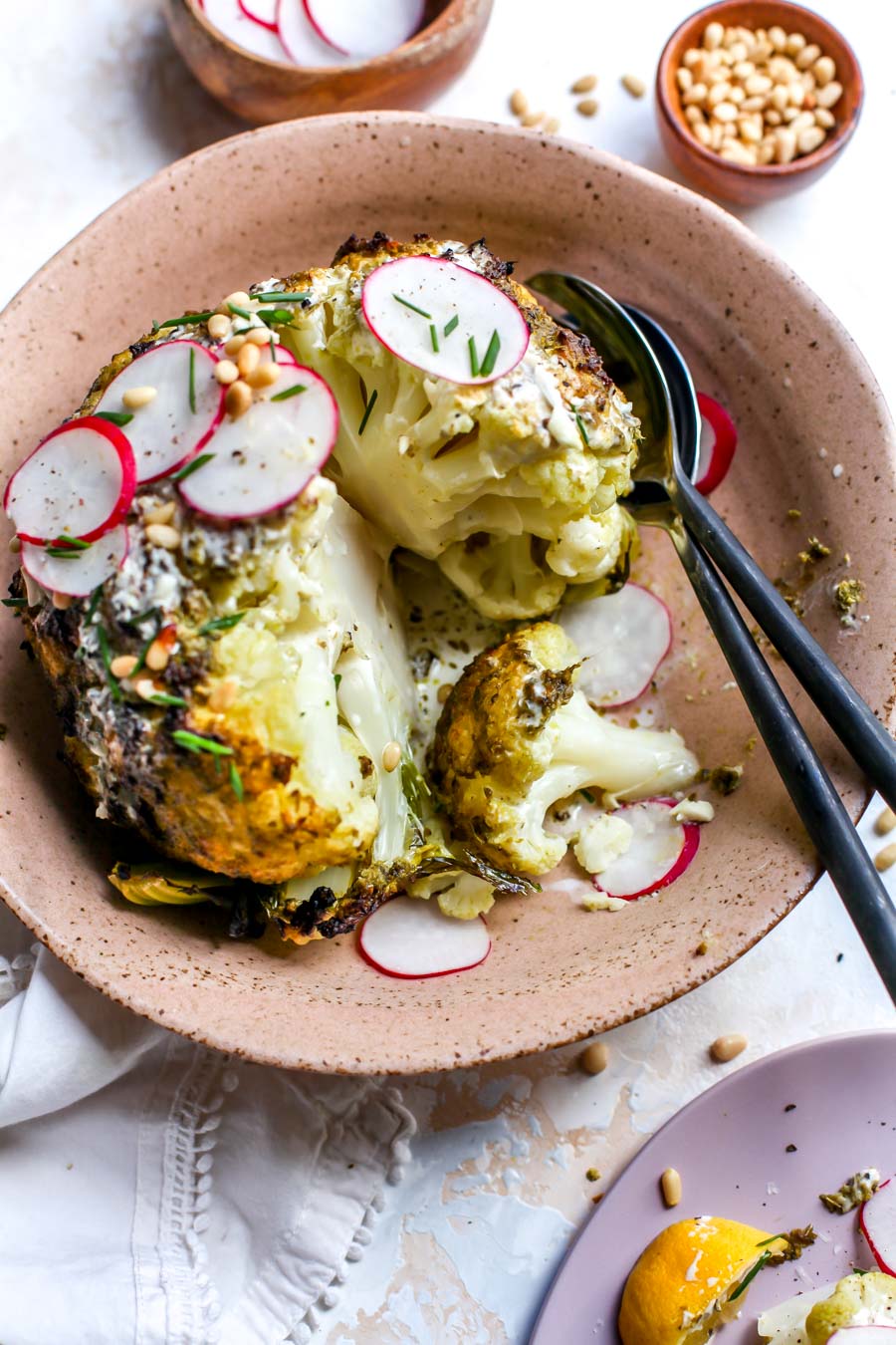 Pesto-Roasted Whole Cauliflower with Creamy Garlic Sauce