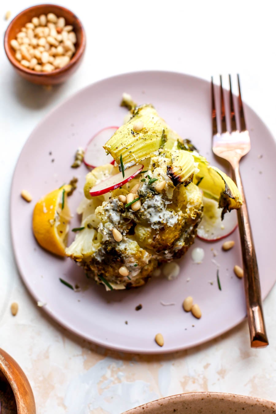 Pesto-Roasted Whole Cauliflower with Creamy Garlic Sauce