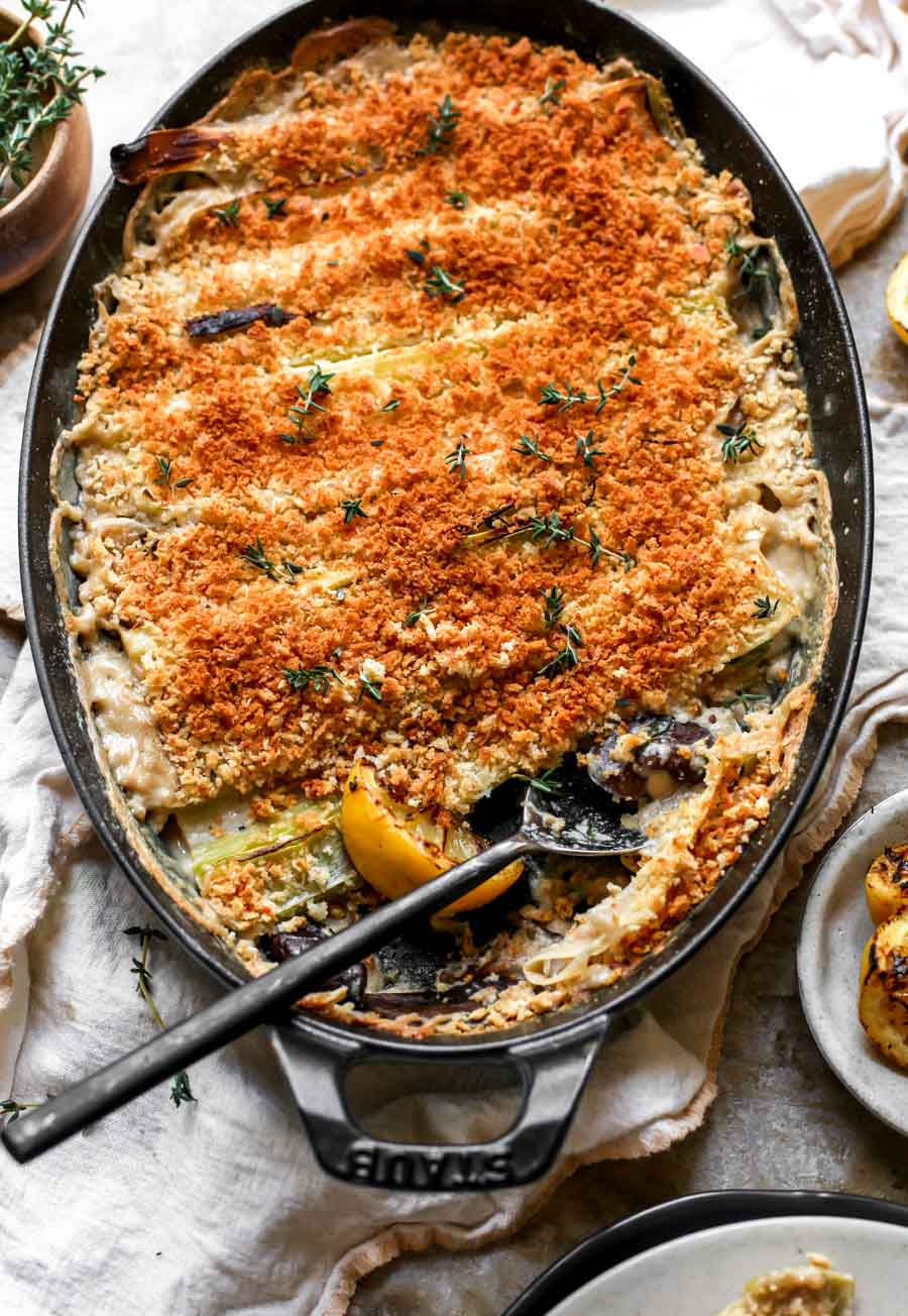 Spring Leek and Mushroom Gratin styled in a cast iron oval baking dish.