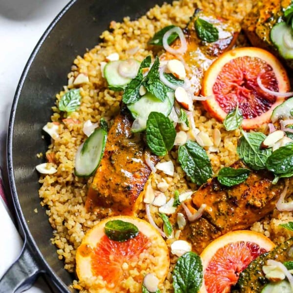 Turmeric-glazed salmon in a pan with bulgur wheat