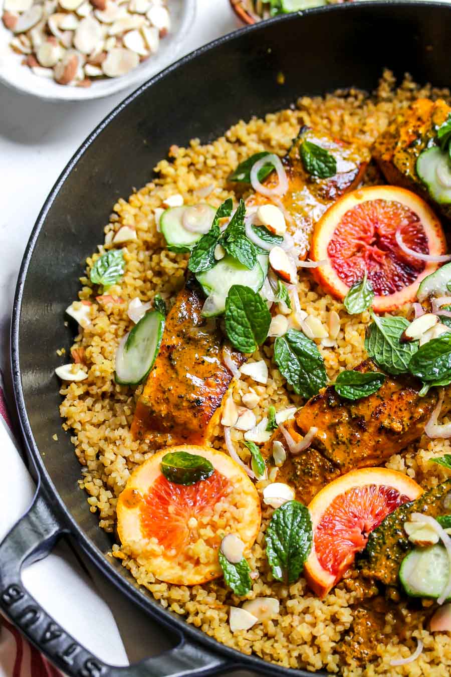 Turmeric-glazed salmon in a pan with bulgur wheat