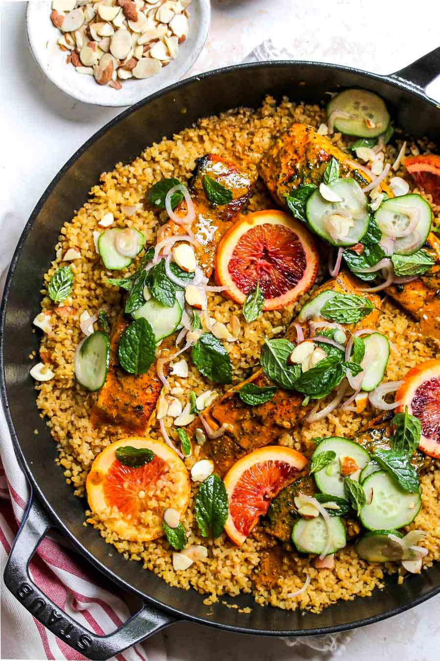 Turmeric-glaze salmon in a skillet with bulgur