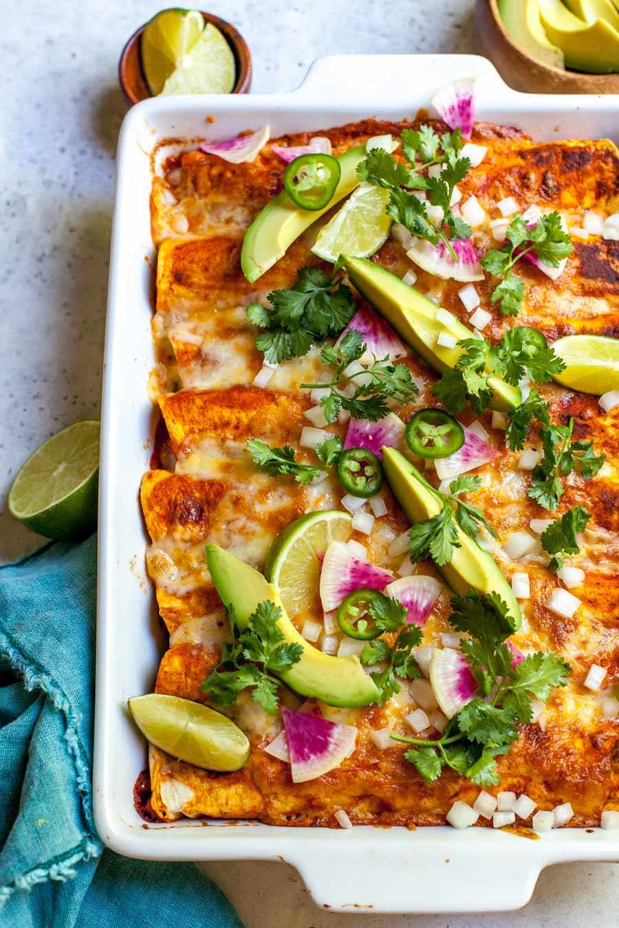 Zucchini and quinoa enchiladas with red sauce and avocado