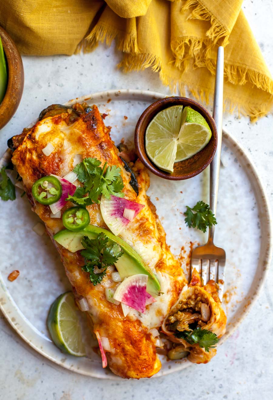 Single portion of enchiladas with garnishes