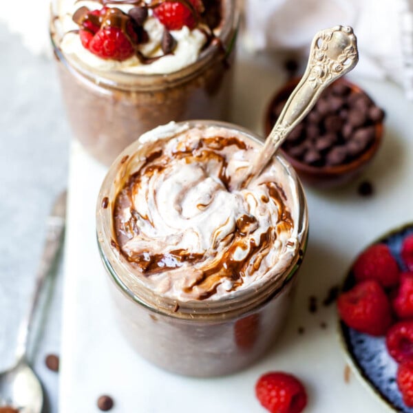 Brownie Batter Overnight Oats topped with yogurt and berries