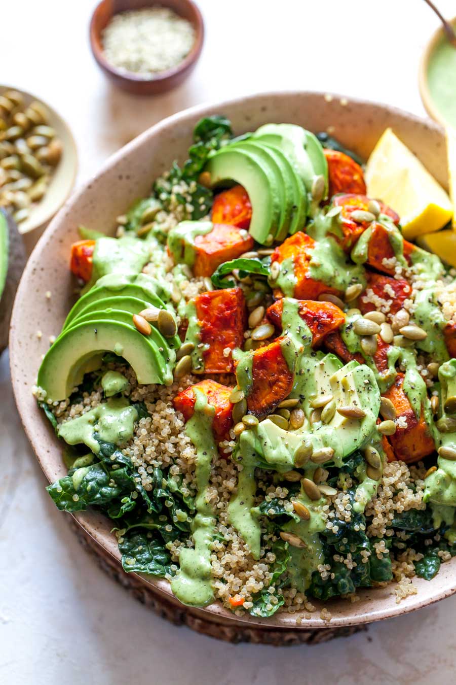 Roasted Sweet Potato salad with quinoa, tahini dressing, and avocado in a large serving bowl