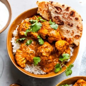 Vegetarian Butter Cauliflower recipe served over basmati rice with yogurt and naan