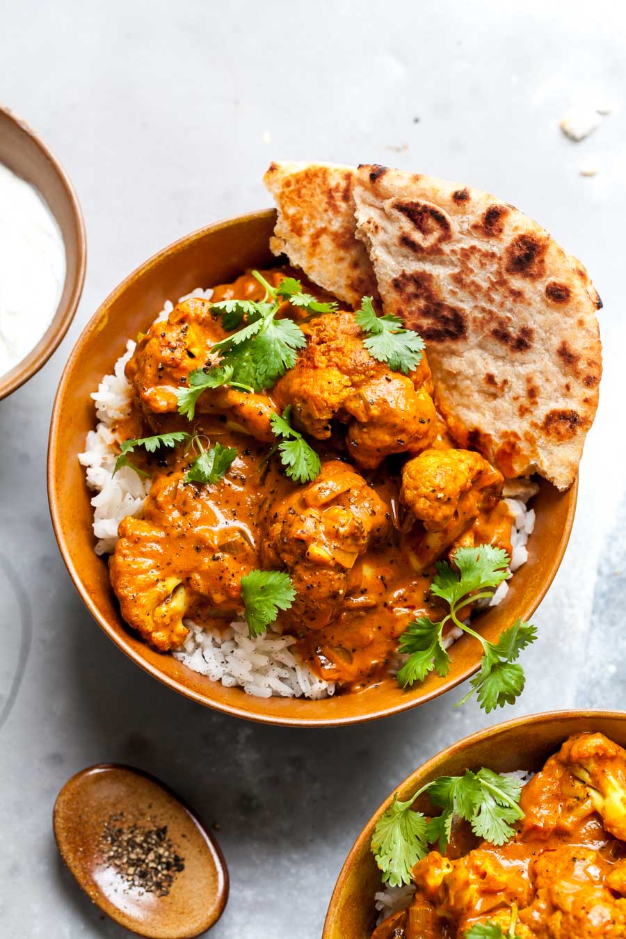 Vegetarian Butter Cauliflower recipe served over basmati rice with yogurt and naan