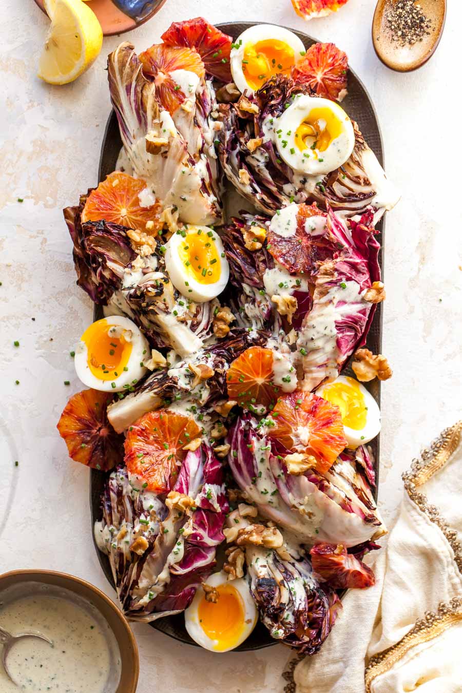 Radicchio Salad with Miso Dressing, soft boiled eggs, citrus, and walnuts.