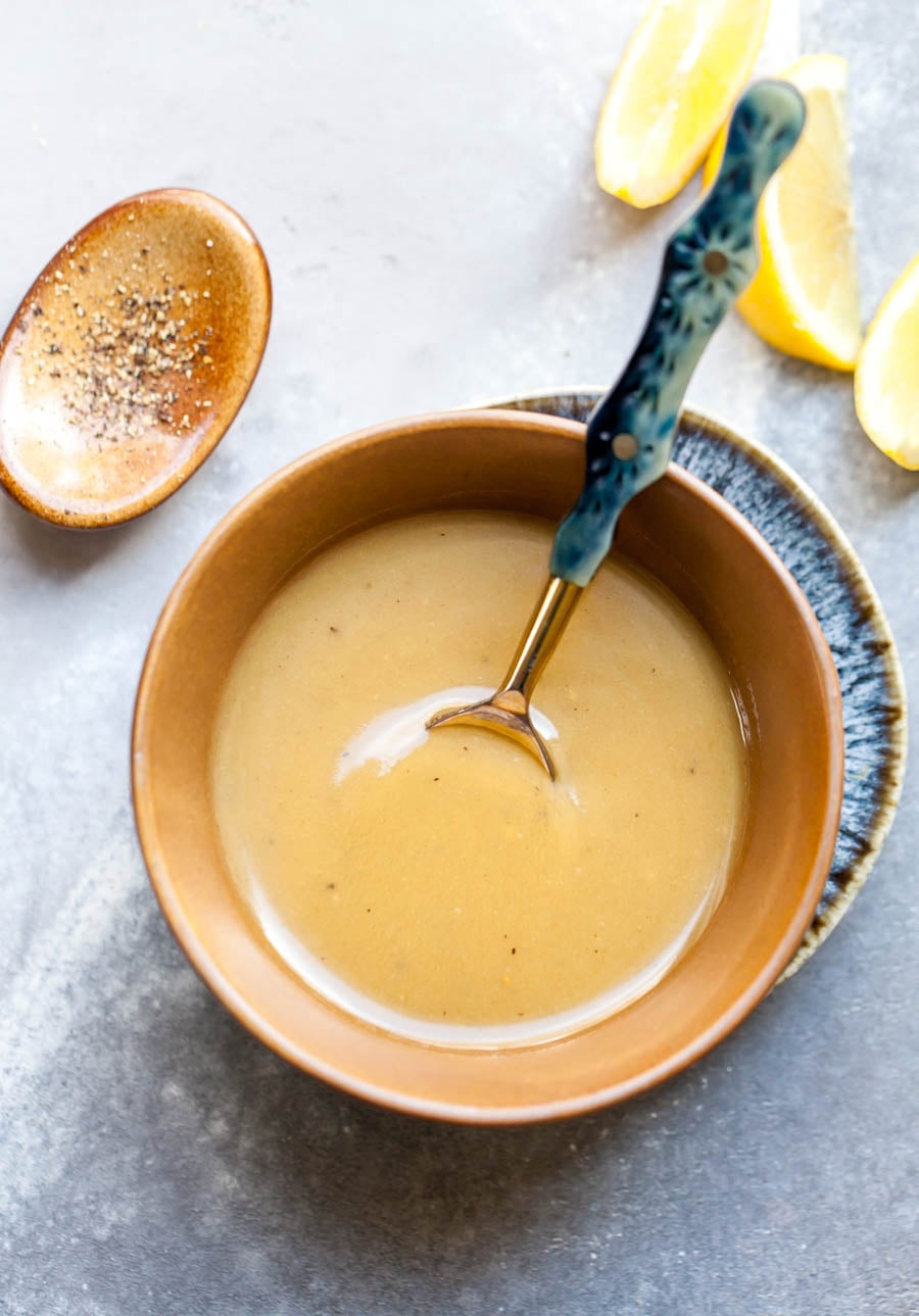 Tahini-honey being mixed in a gold bowl