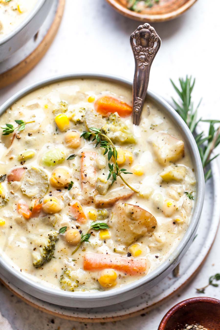 Creamy vegetable soup styled in a white bowl with a spoon resting on the right side.