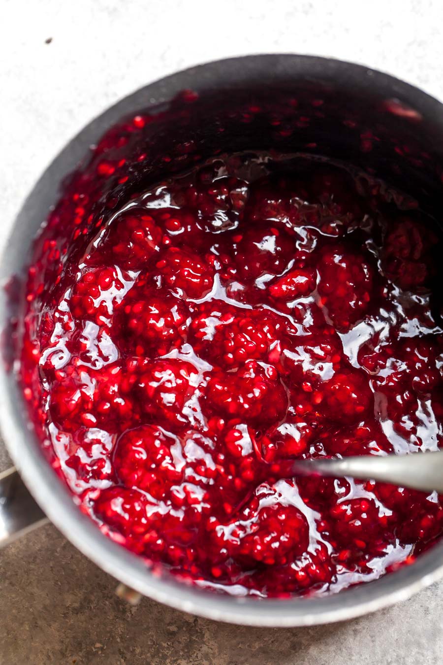 Blackberries cooking with lemon zest