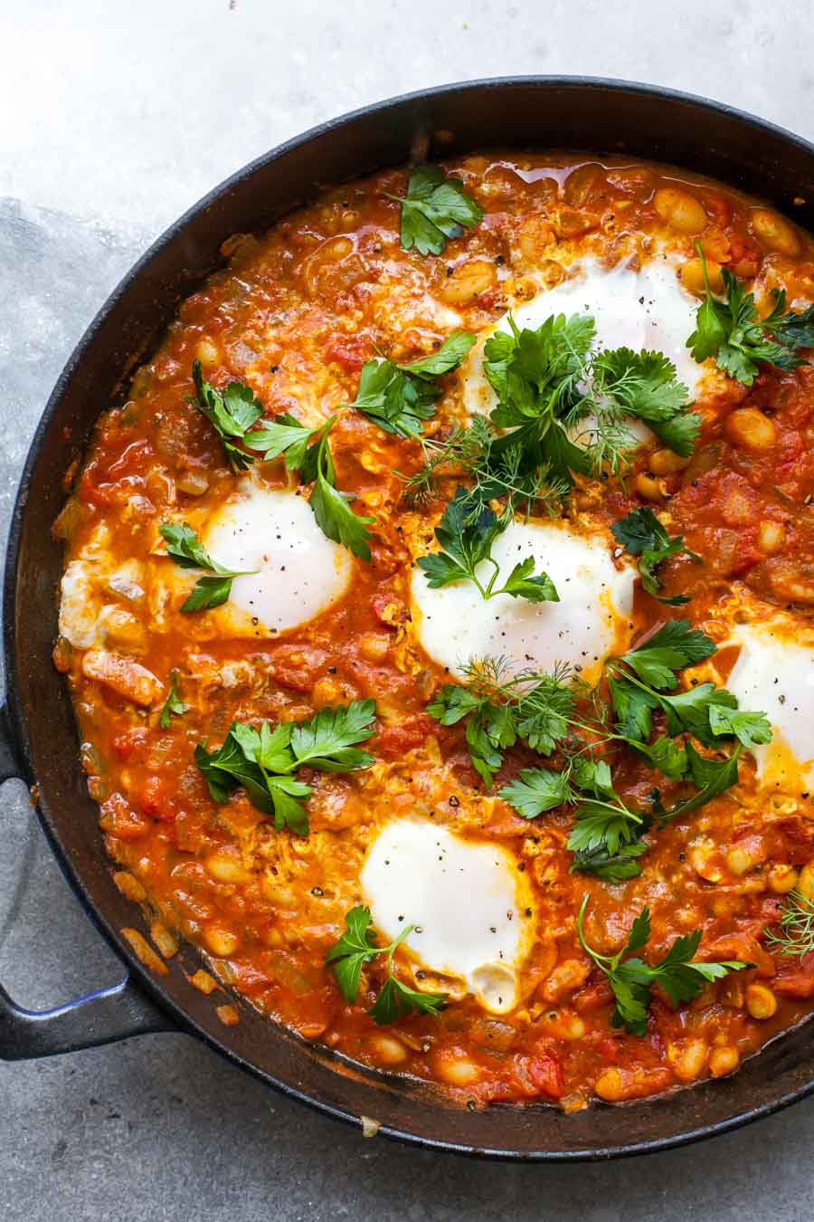 Finished skillet of tomato-poached eggs
