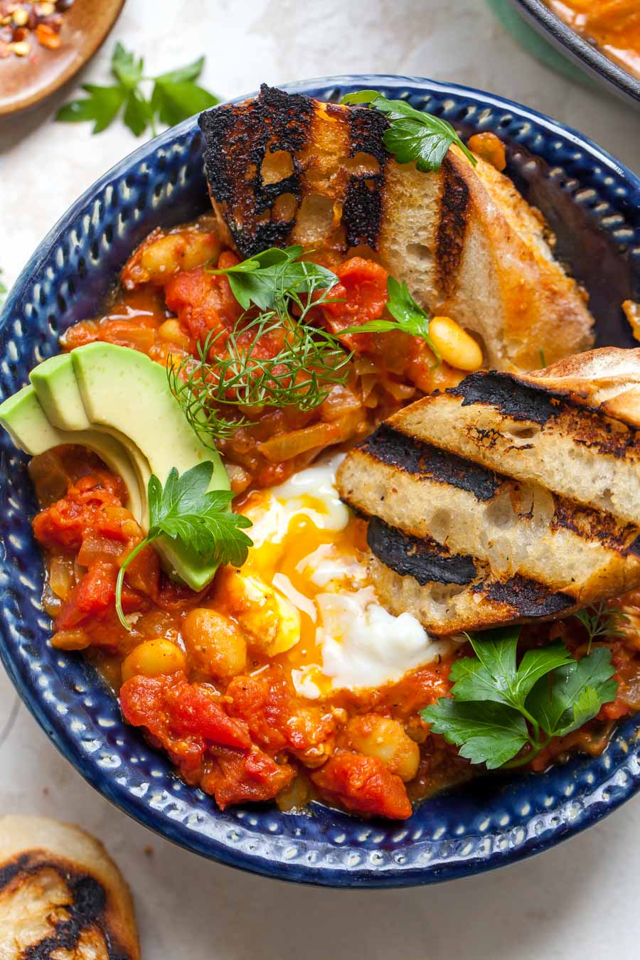 Grilled bread dipped in coconut-curry poached eggs