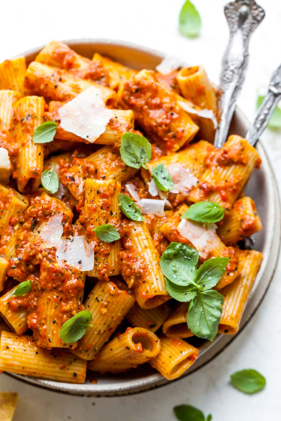 Red pesto pasta styled in a bowl to showcase summer pasta recipes.