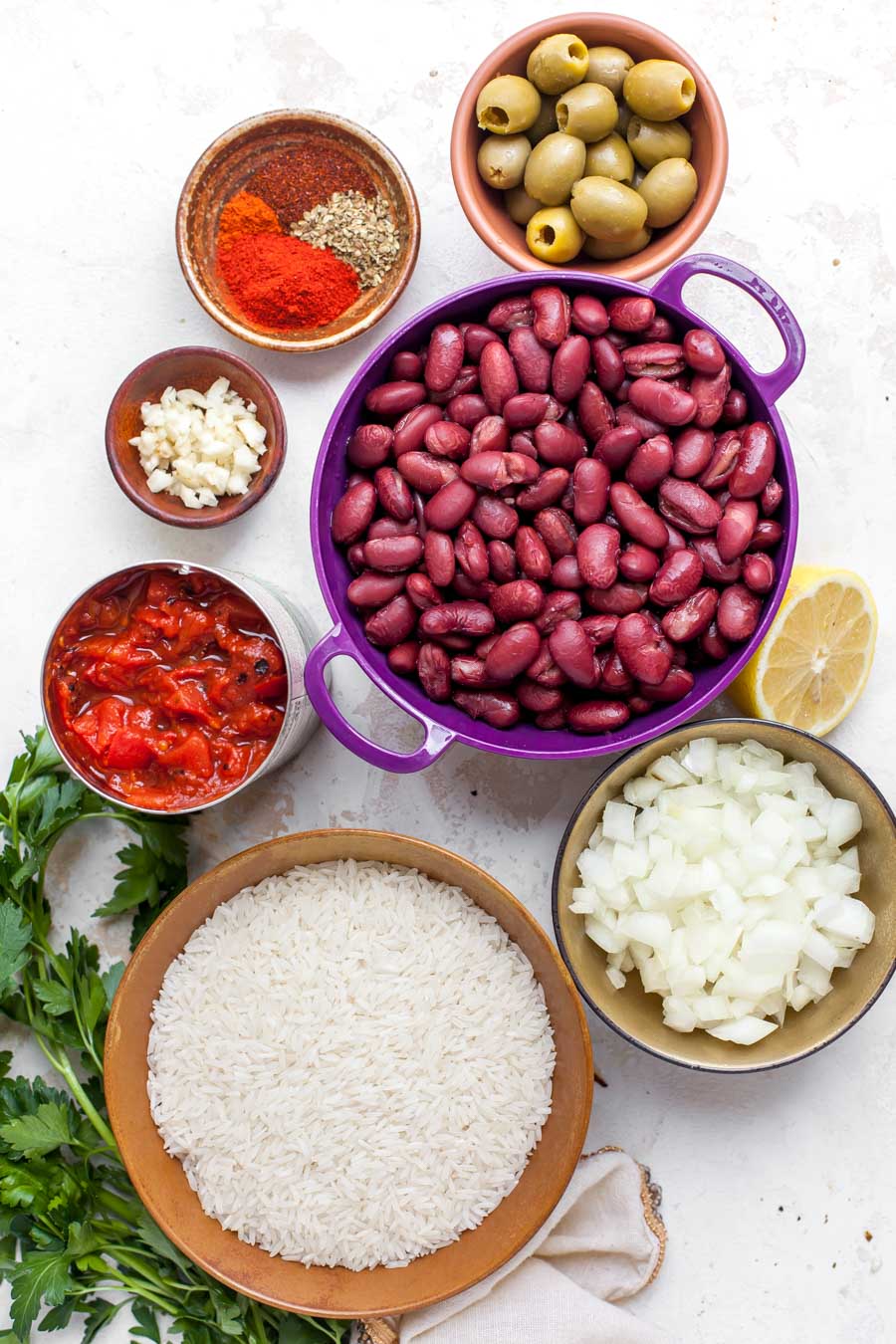 Ingredient photo showing rice, beans, spices, and tomatoes