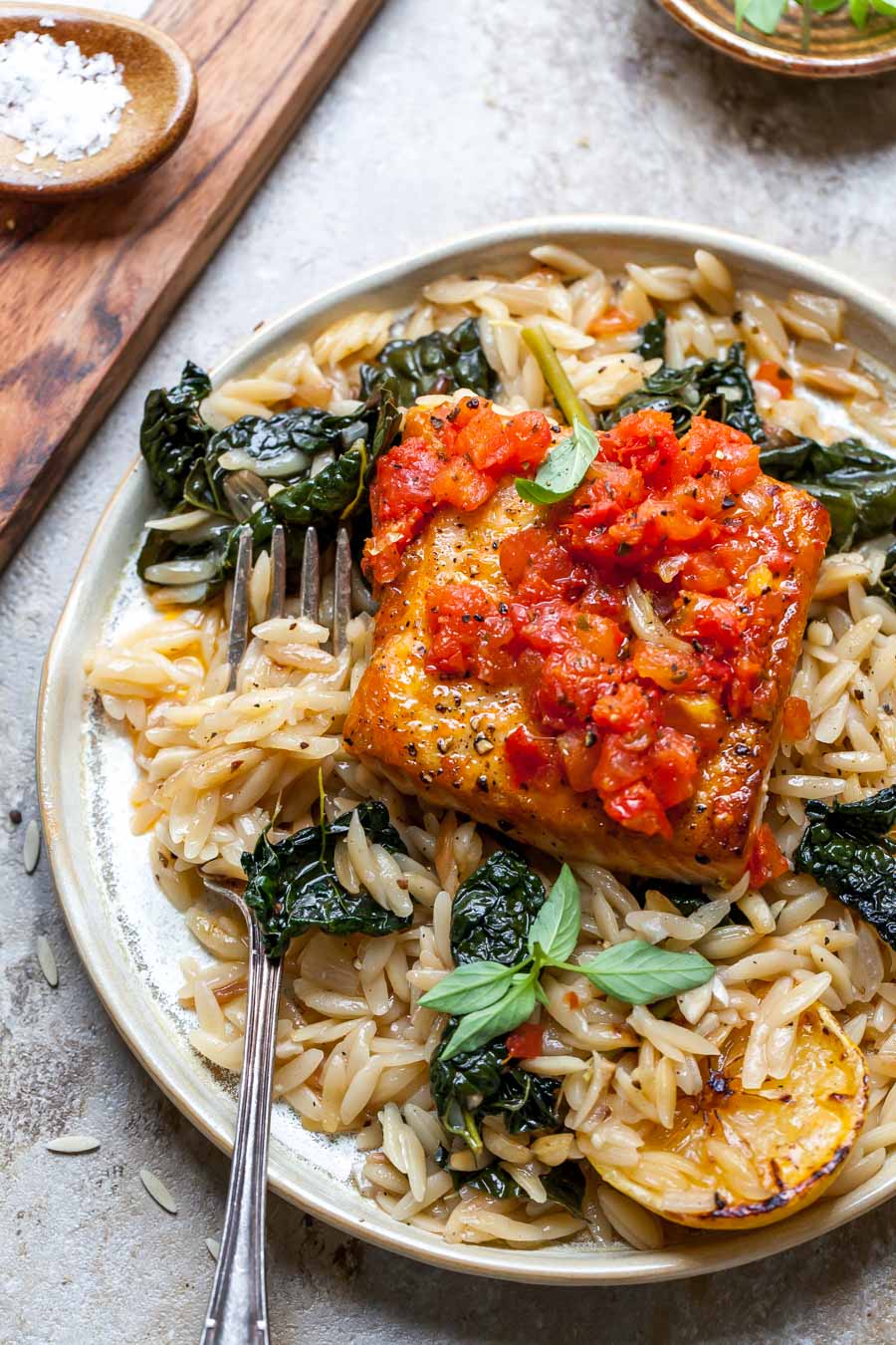 Salmon served with orzo on a plate