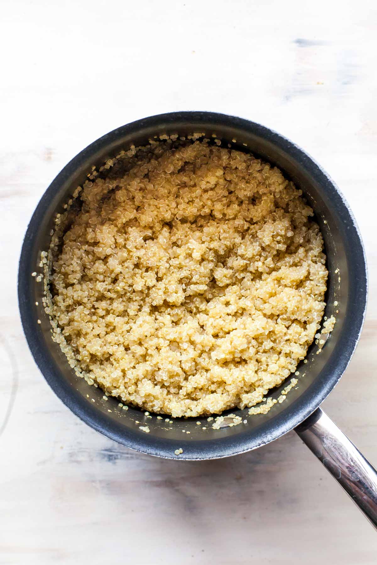 Cooked quinoa in a small saucepan