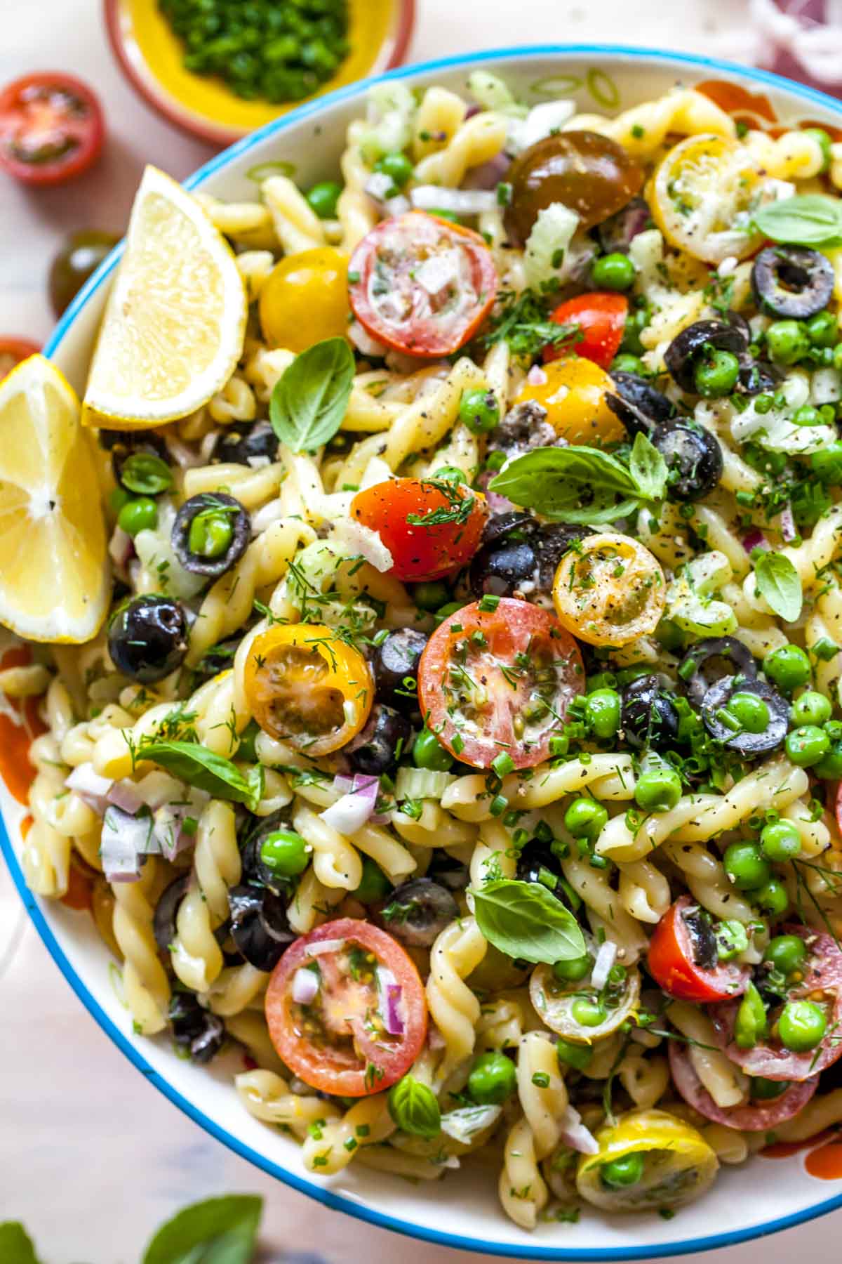 Close up of healthy pasta salad with lemon wedge garnish