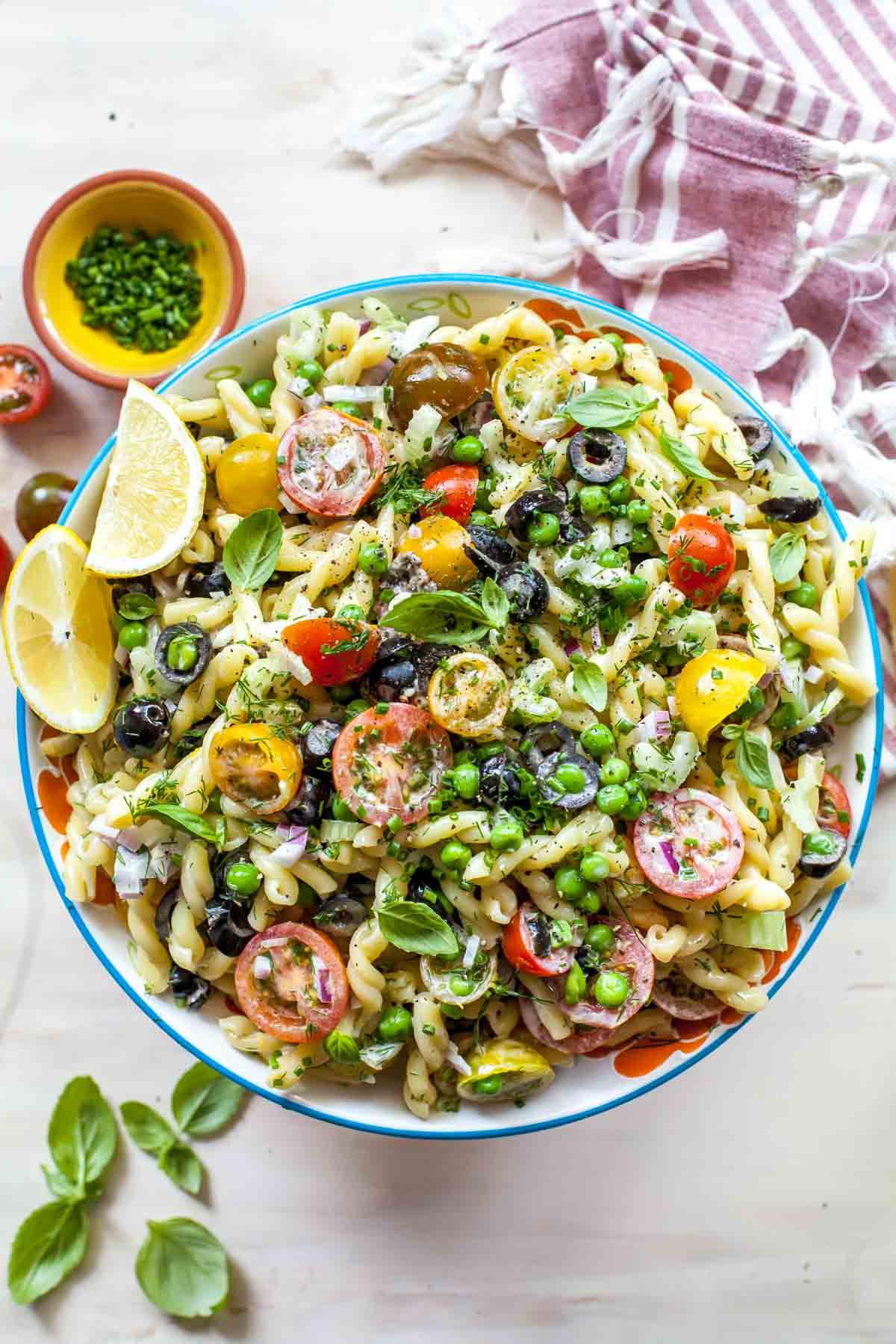 Creamy pasta salad with chives, dill, and tomatoes tossed with lemon dressing