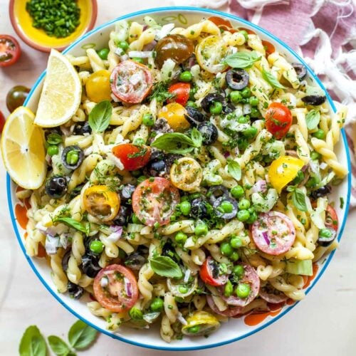 Creamy pasta salad with chives, dill, and tomatoes tossed with lemon dressing