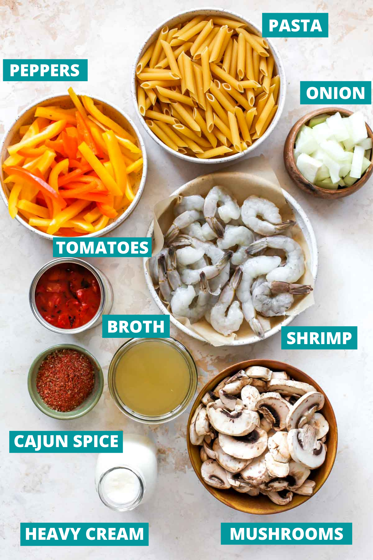 Shrimp, pasta, vegetables, and cajun spice in separate bowls with ingredient labels