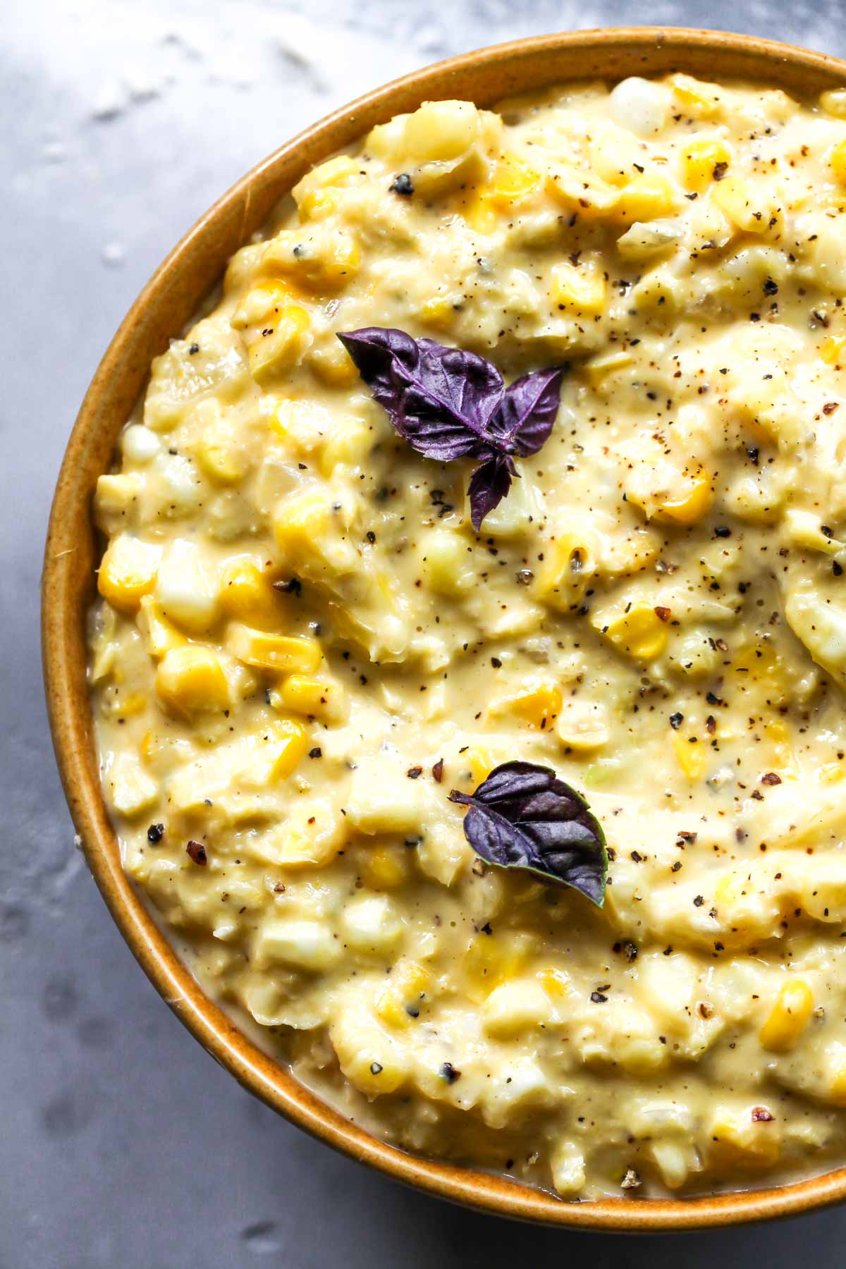 Close up of creamed corn in a gold bowl