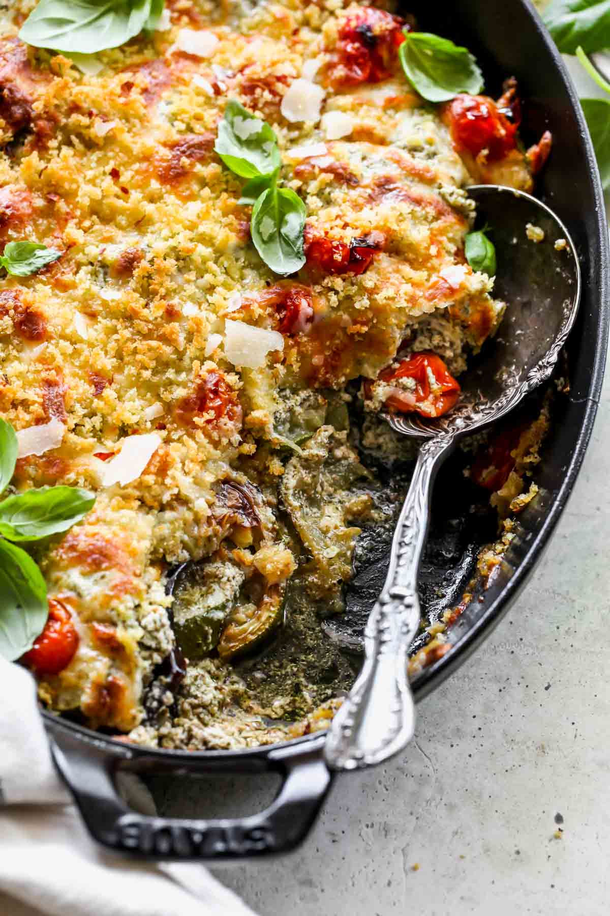 A spoon pulling a serving of eggplant lasagna out