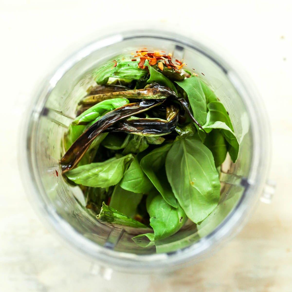 Basil, scallions, red pepper flakes, and olive oil combined a mini blender.