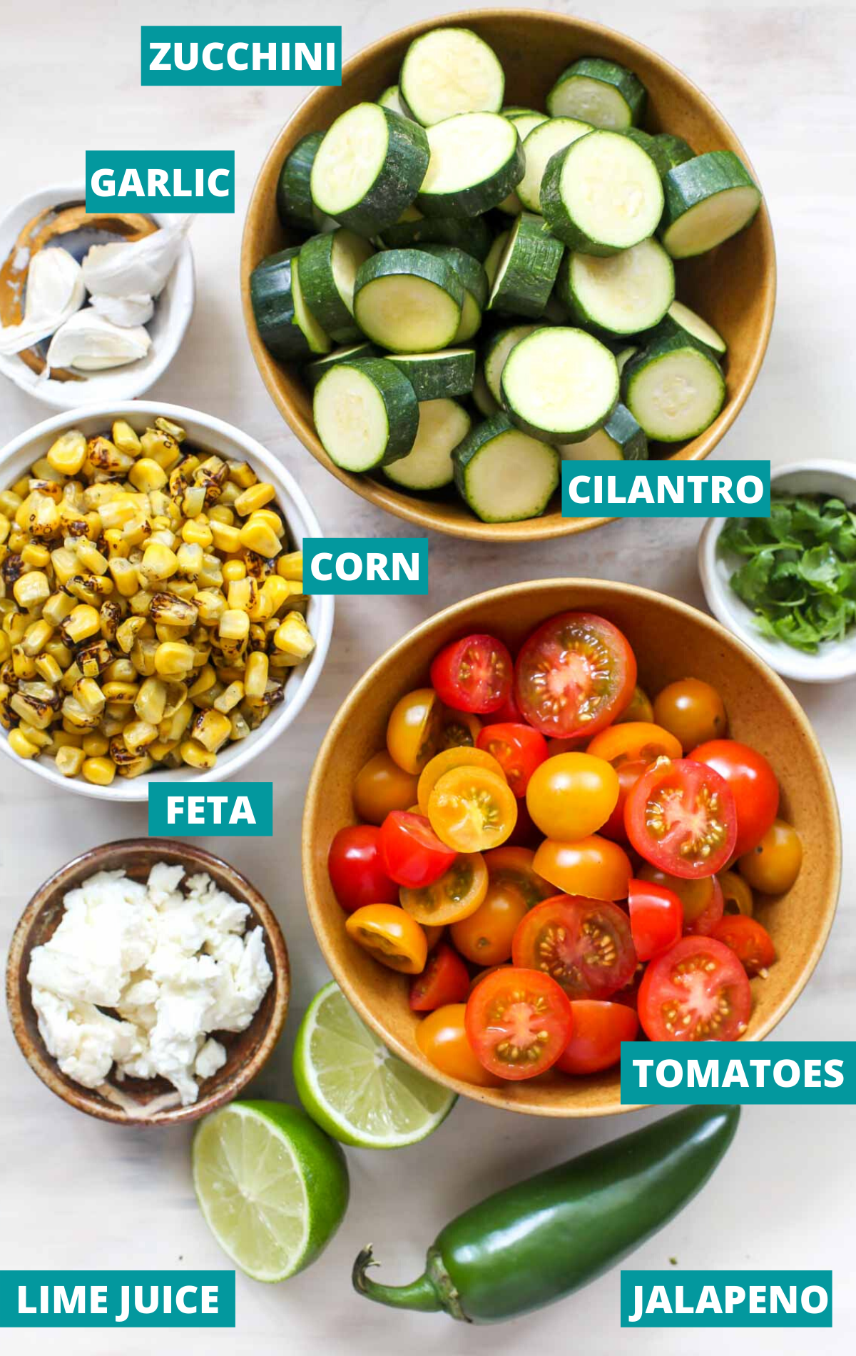 Salad components in separate bowls with blue ingredient labels