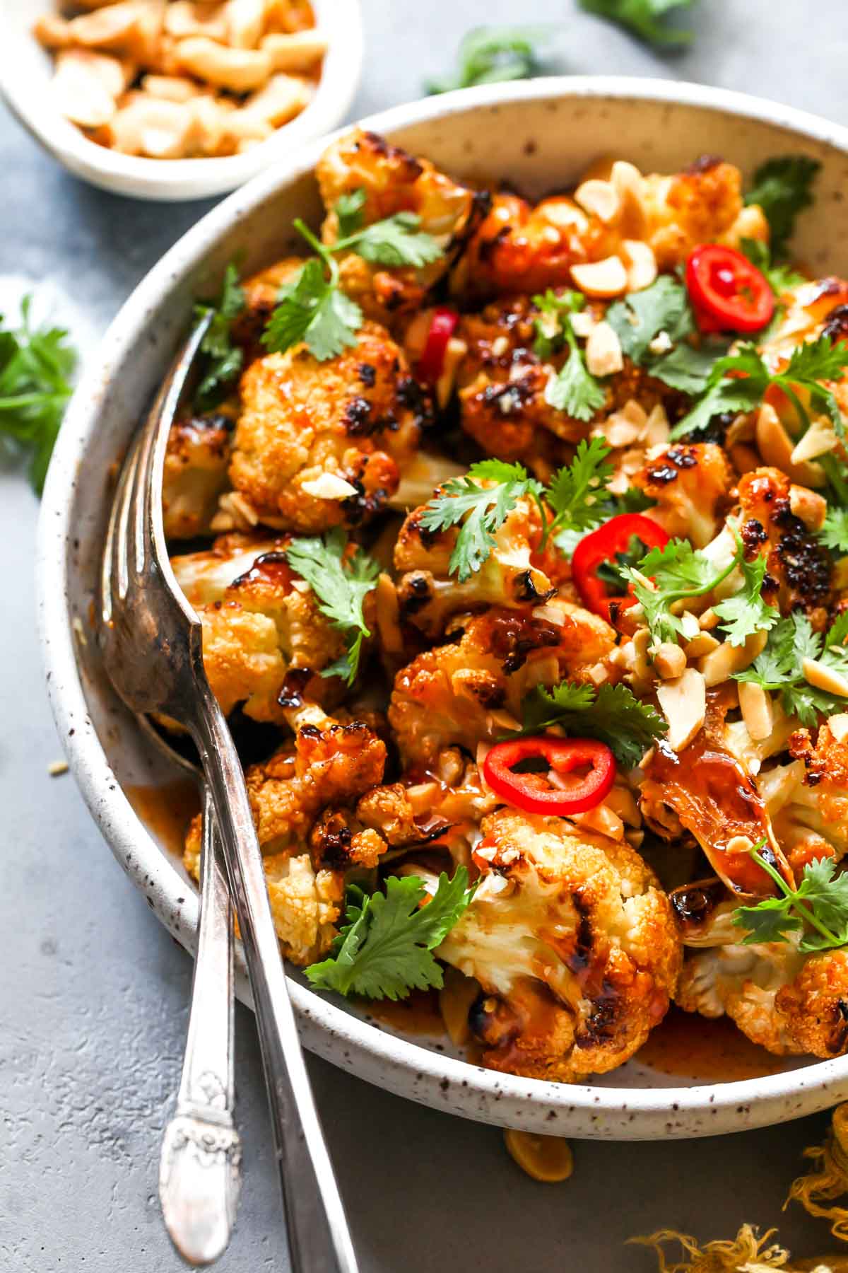 Spoon and fork in a bowl of roasted cauliflower