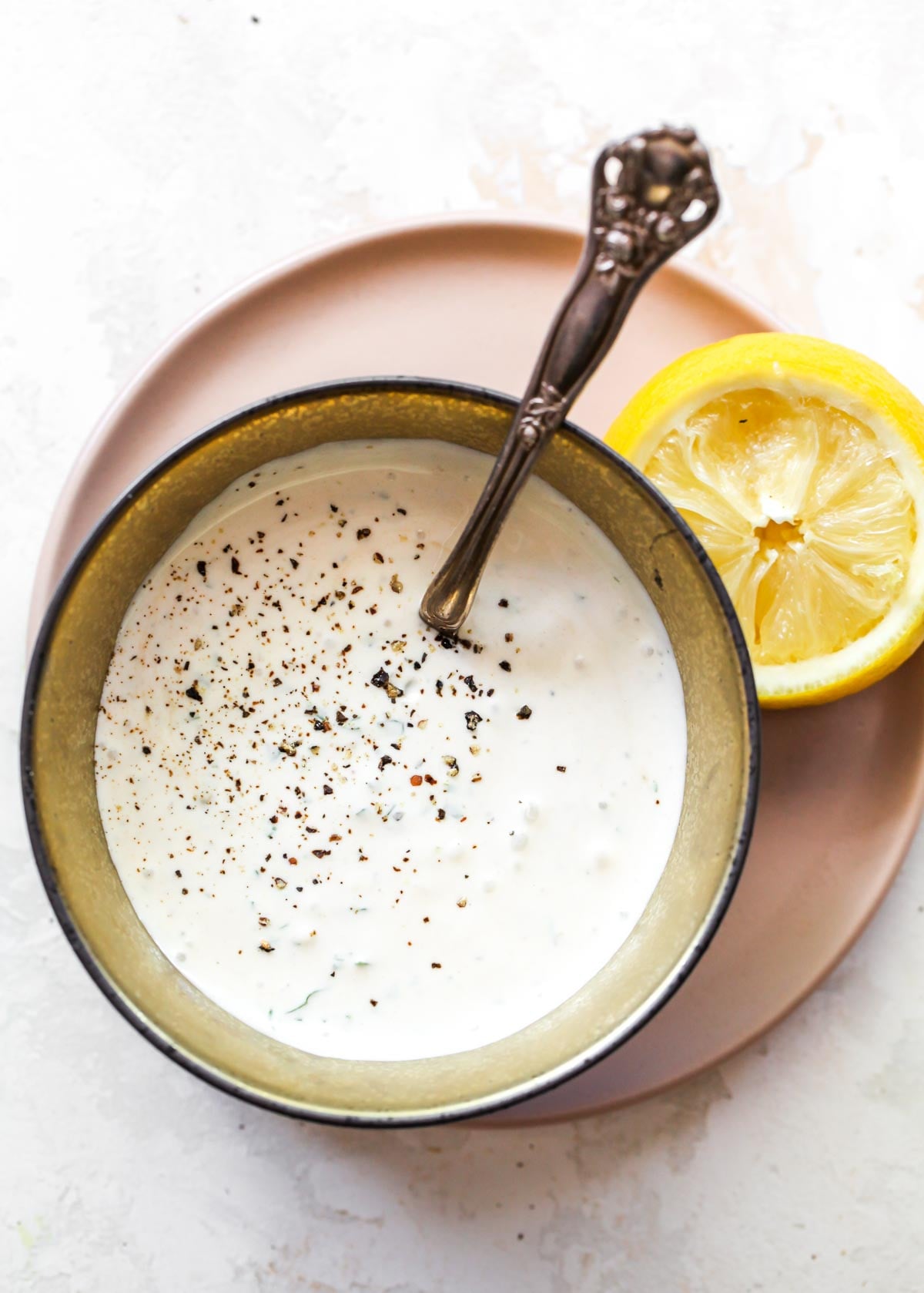 Garb herb cream sauce in a small gold bowl