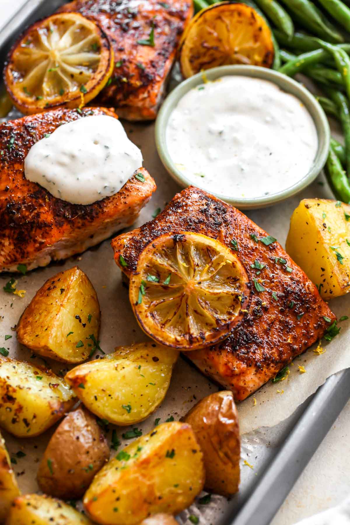 Close up of salmon topped with garlic herb sauce