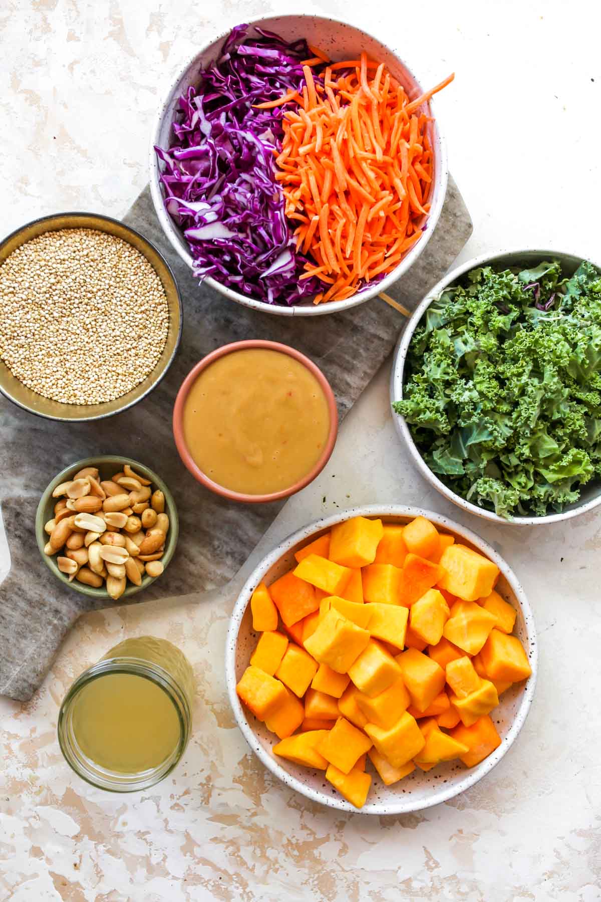 Recipe ingredients in separate bowls on a white board