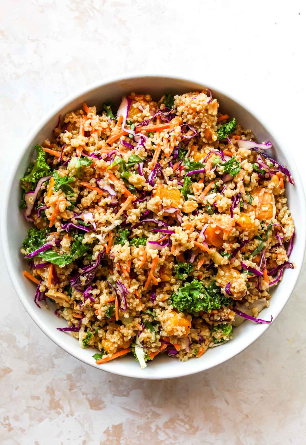 Butternut squash quinoa salad mixed together in a white bowl