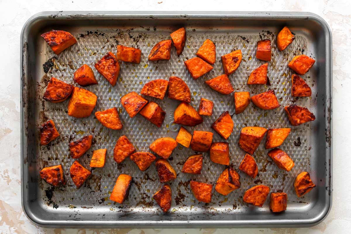 Roasted sweet potatoes on a silver sheet pan