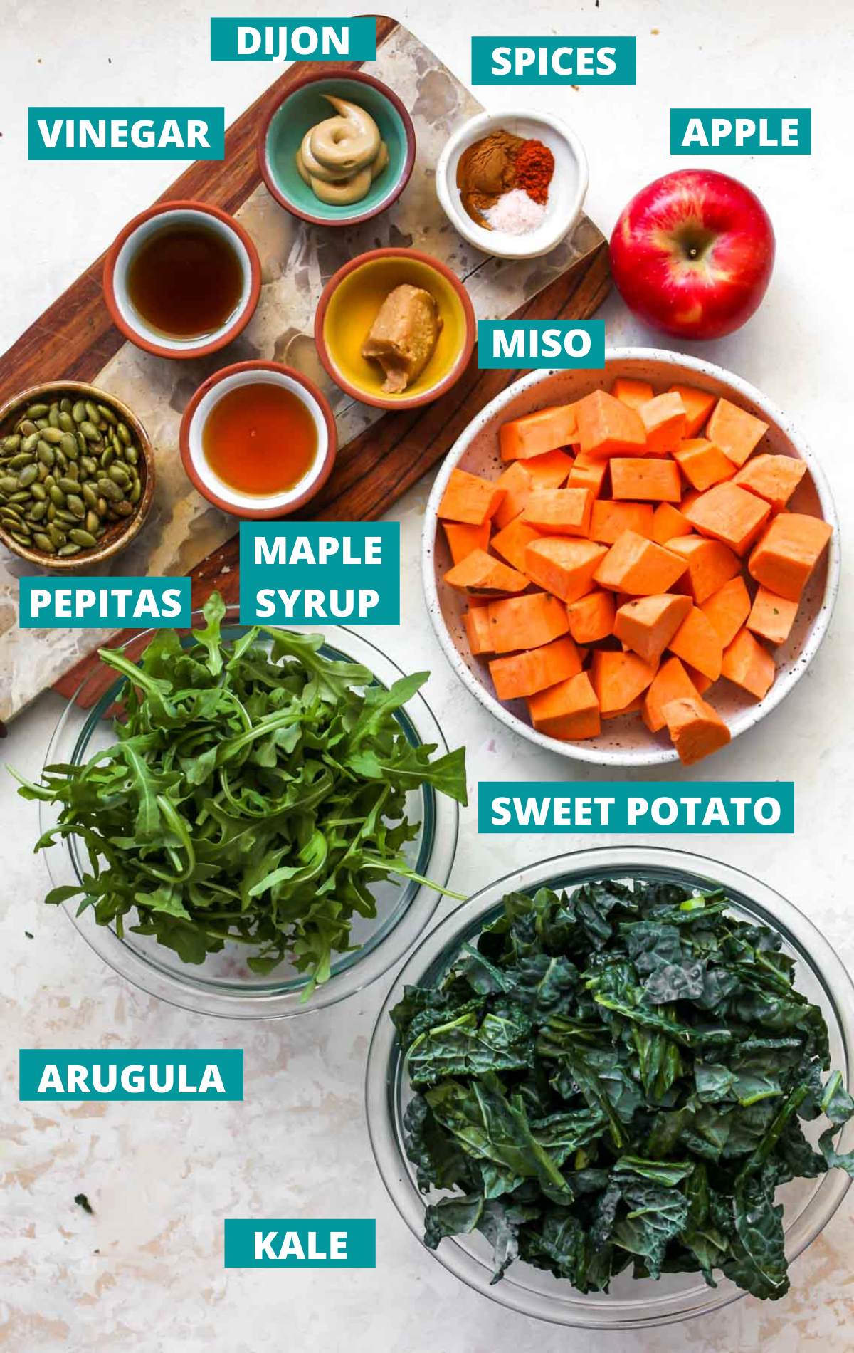 Fall salad ingredients in separate bowls with blue labels