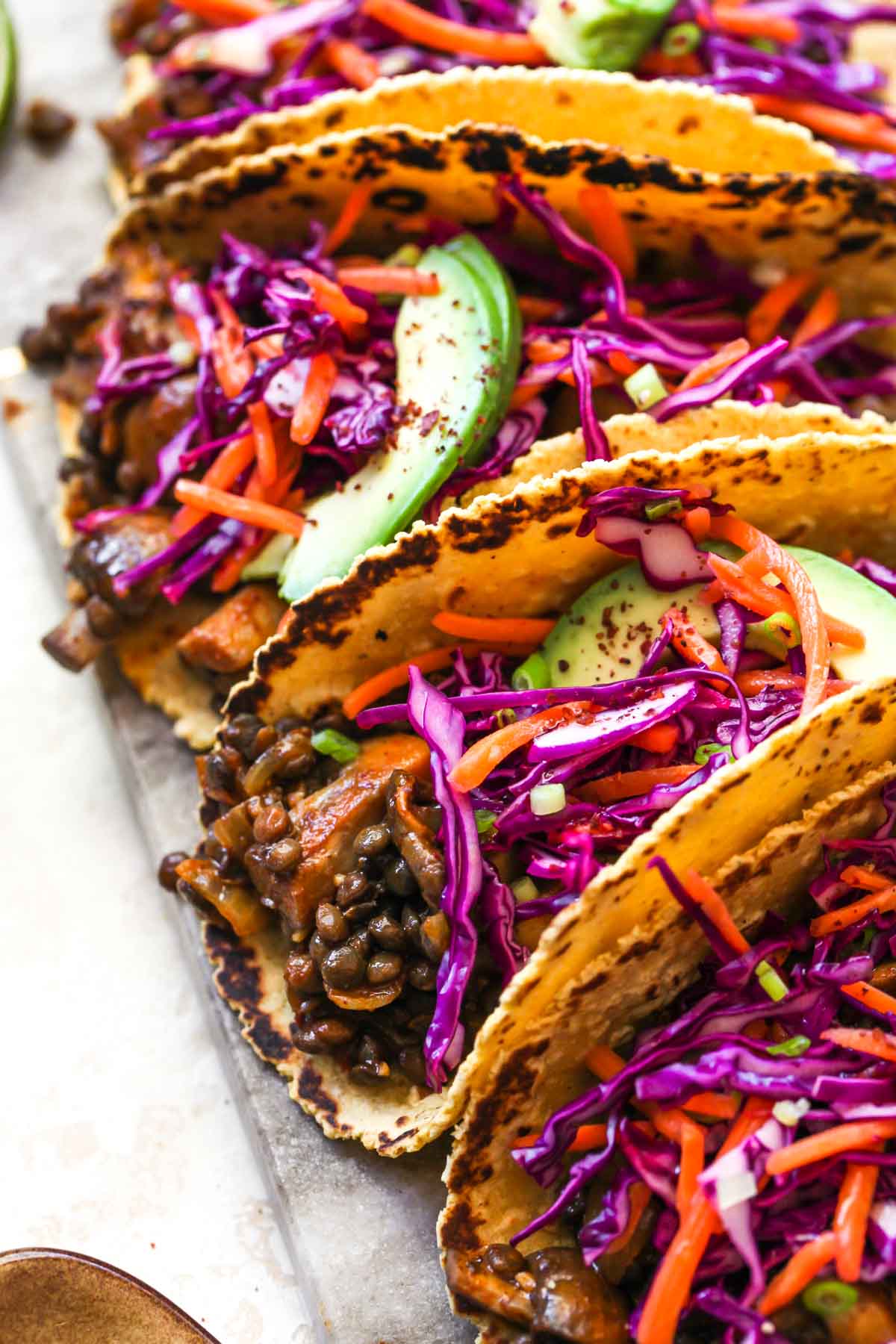 Vegetarian taco filling topped with cabbage slaw and sliced avocado