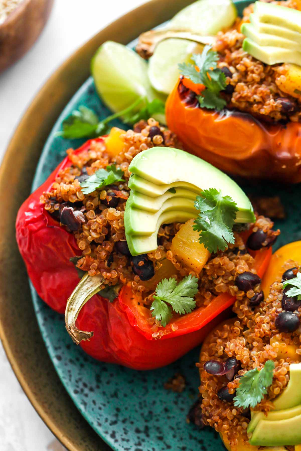 Red pepper half filled with Tex-Mex quinoa on a blue plate