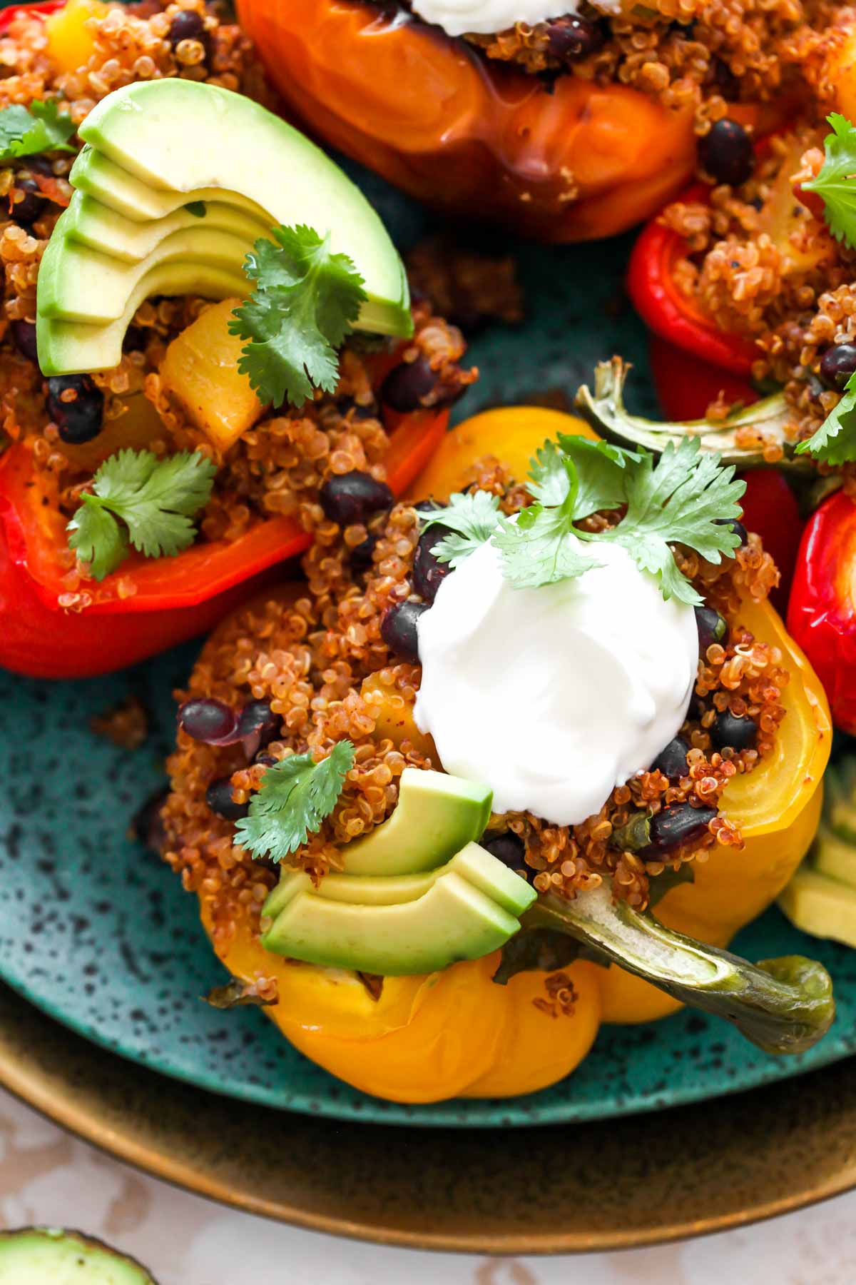 Yogurt and avocado on top of a stuffed bell pepper half